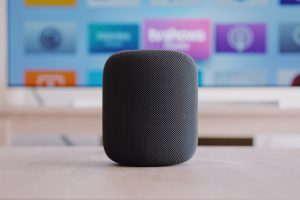 black Apple HomePod speaker on table
